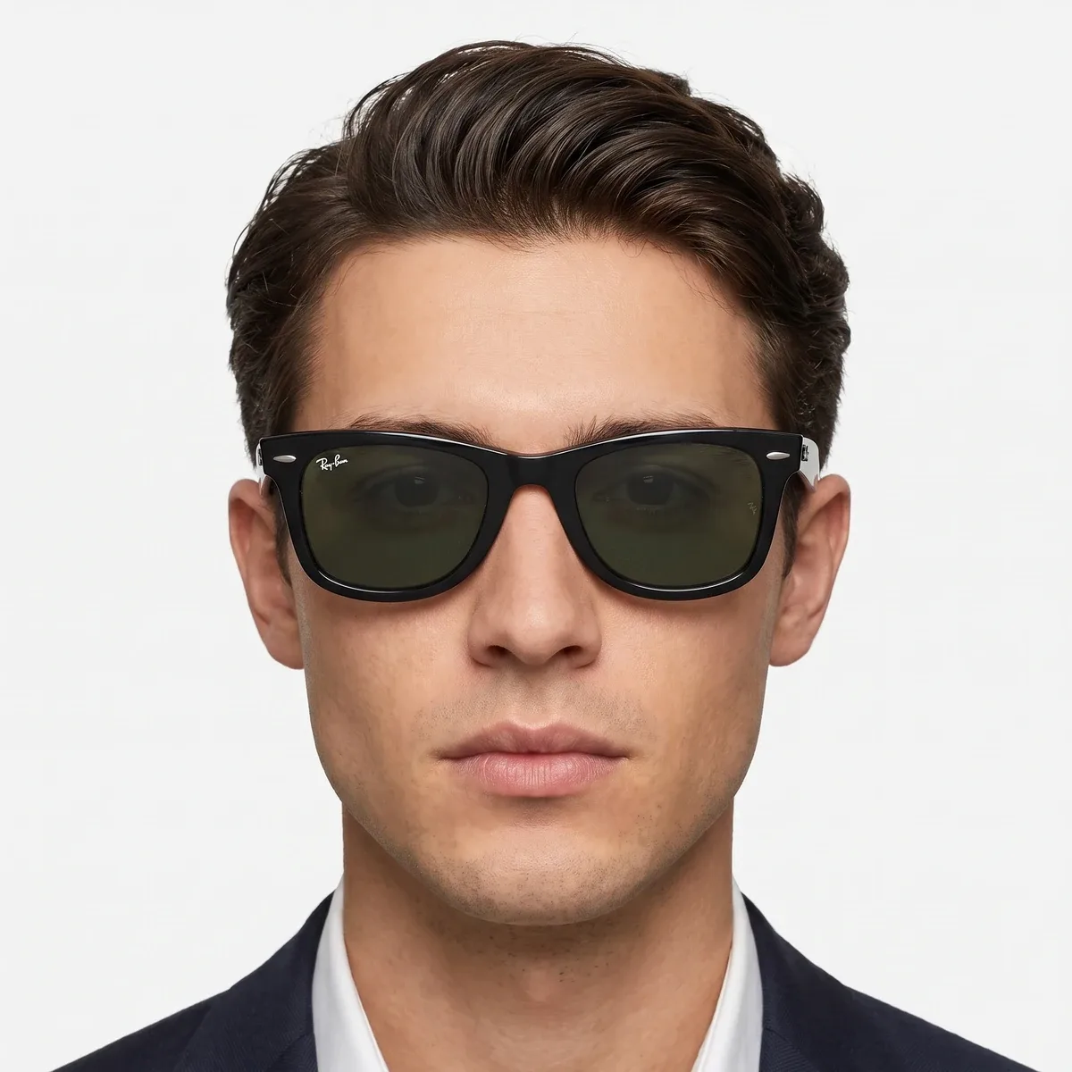 Close portrait of a man wearing dark sunglasses against a pale background.